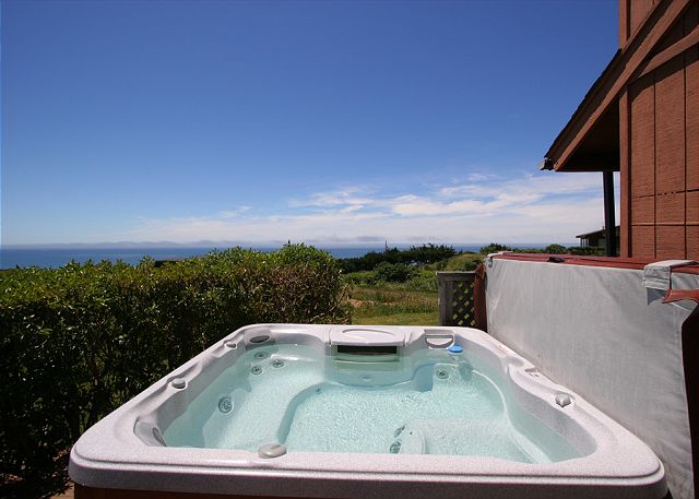 Hot tub near a brown house on a sunny day