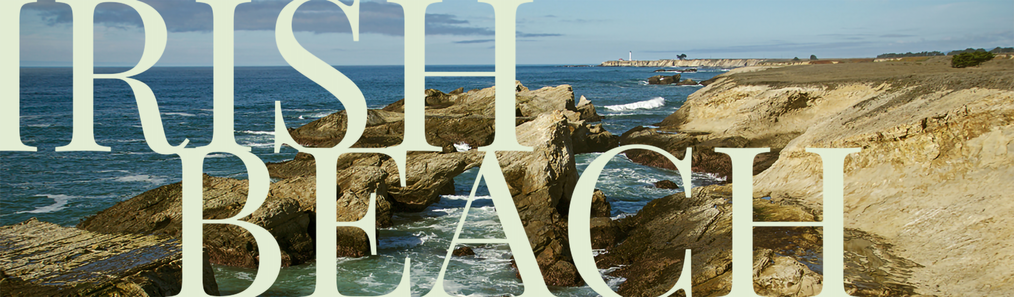 Rocky California coastline with blue ocean waves crashing into it. Irish Beach text overlays image.