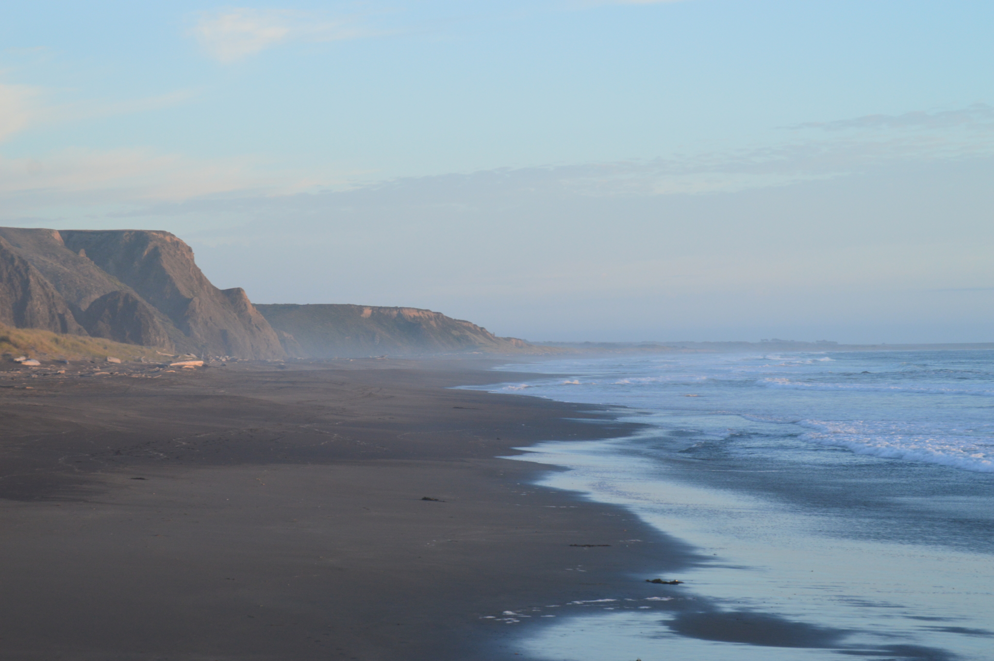 Oceanside cliffs leading to a sandy beach in Northern California