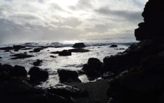 Rocky shoreline with ocean waves crashing into them