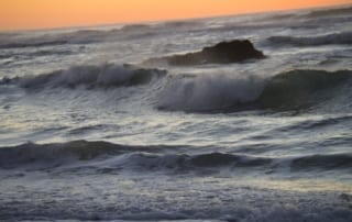 Rolling ocean waves at sunset