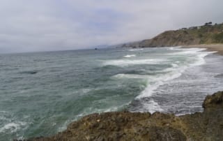 Ocean waves rolling into rocky coastline of Northern California