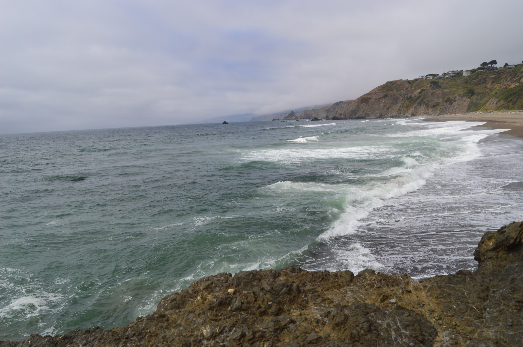 Ocean waves rolling into rocky coastline of Northern California