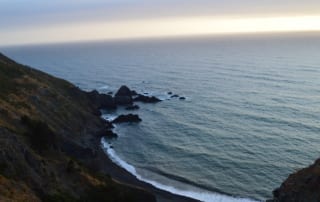 Steep sloping hills leading to ocean on Northern California coast